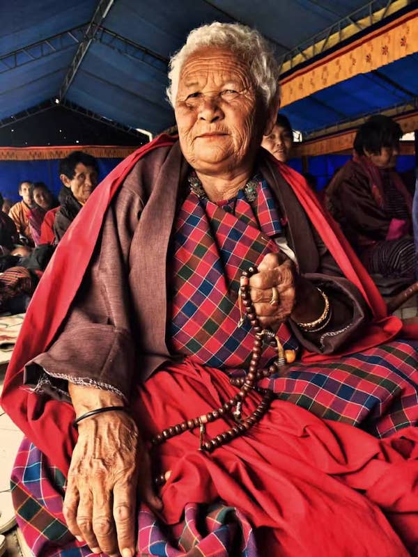 Buddhist follower from Bhutan praying using a Japa mala or mala (meaning garland) which is a set of beads